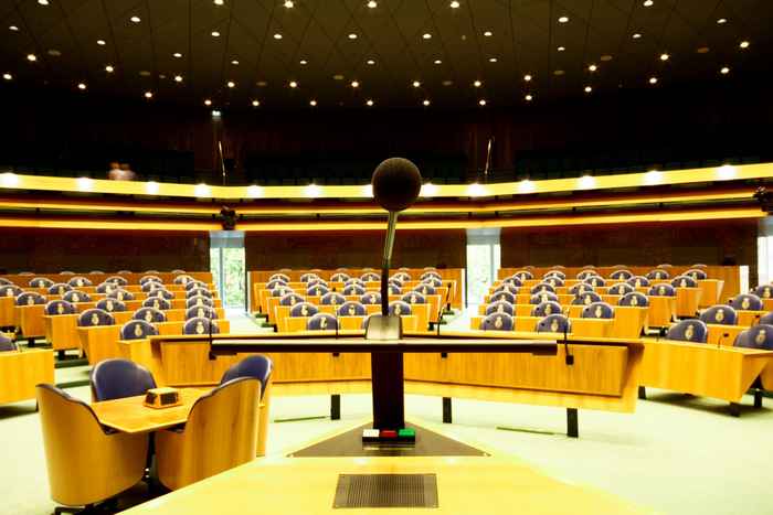 A photograph of an empty lecturn, at the front of an empty lecture hall